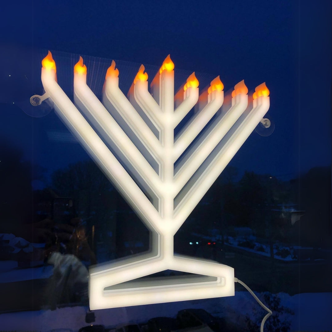 Illumin8 Electric Menorah - Main view showcasing its bright modern design and LED features with dark blue sky.