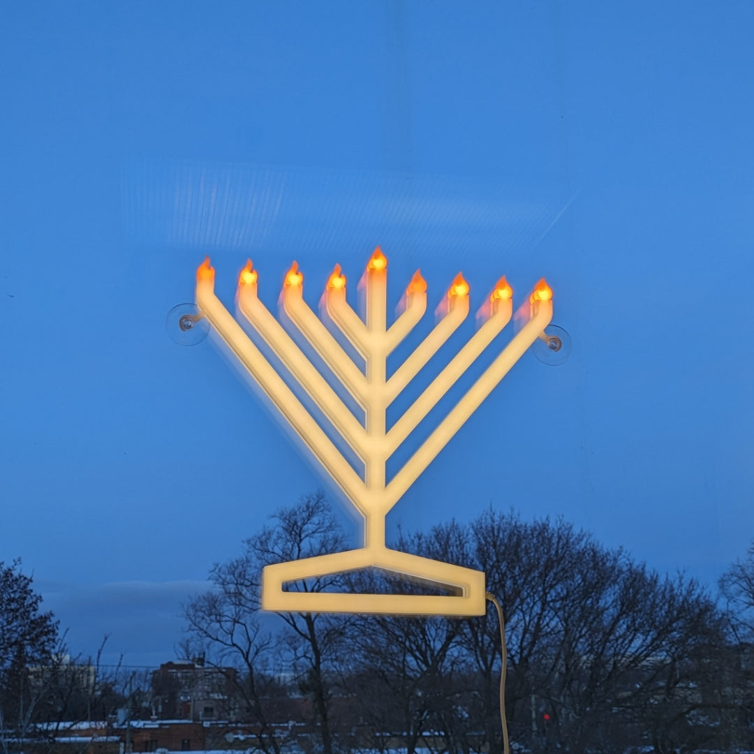 Illumin8 Light Up Menorah displayed in a window, radiating festive cheer for Hanukkah